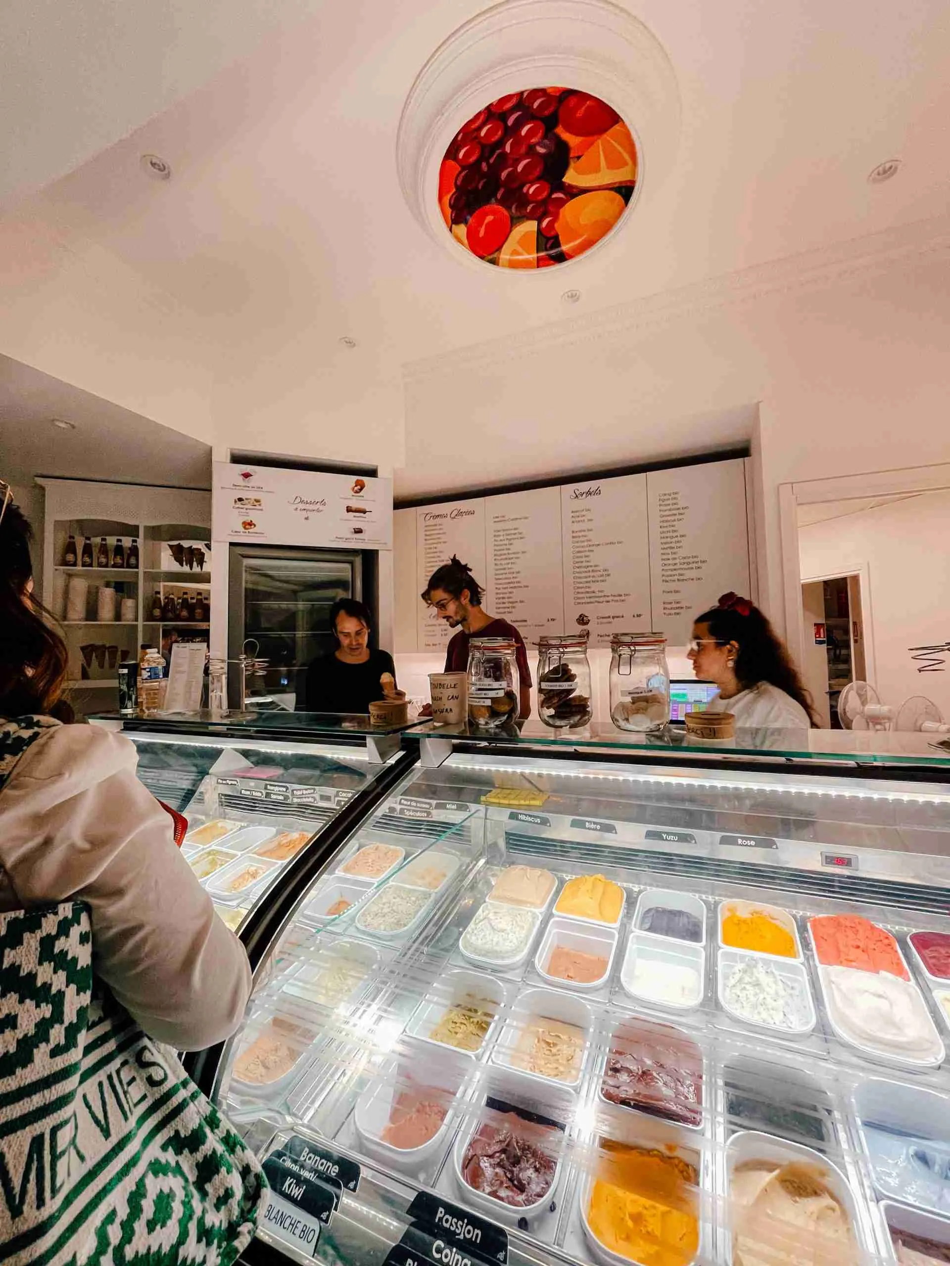 The inside of an ice cream parlour displaying many different flavours
