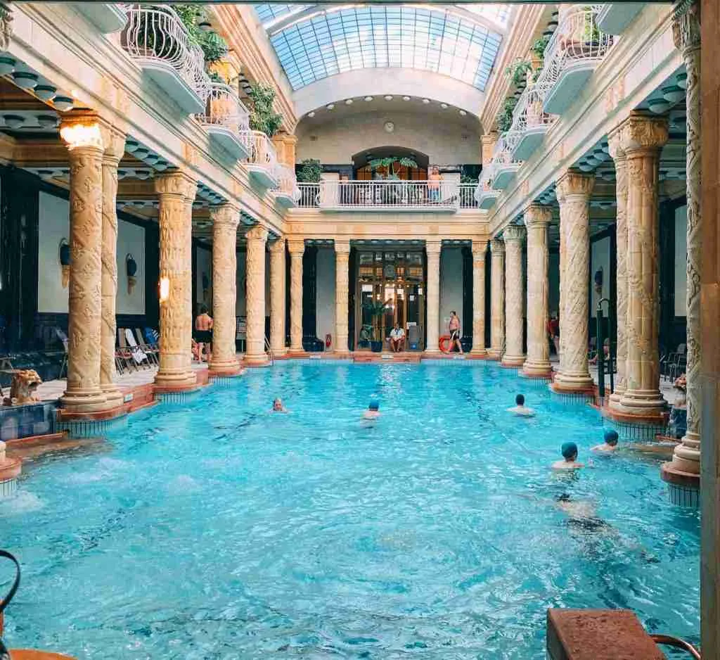 A beautiful indoor pool surrounded by columns in Budapest