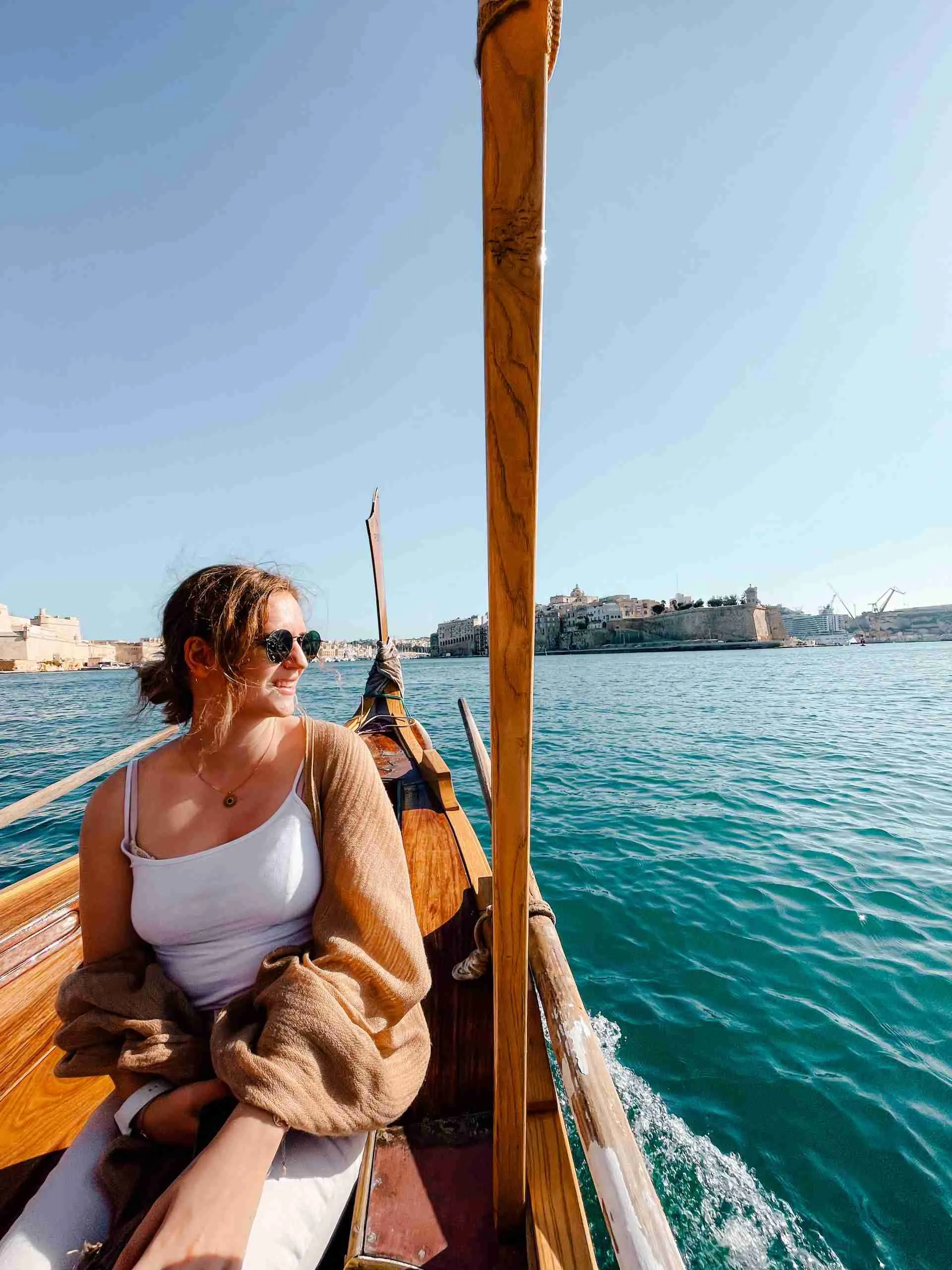 girl looking out at the water while riding a Maltese boat
