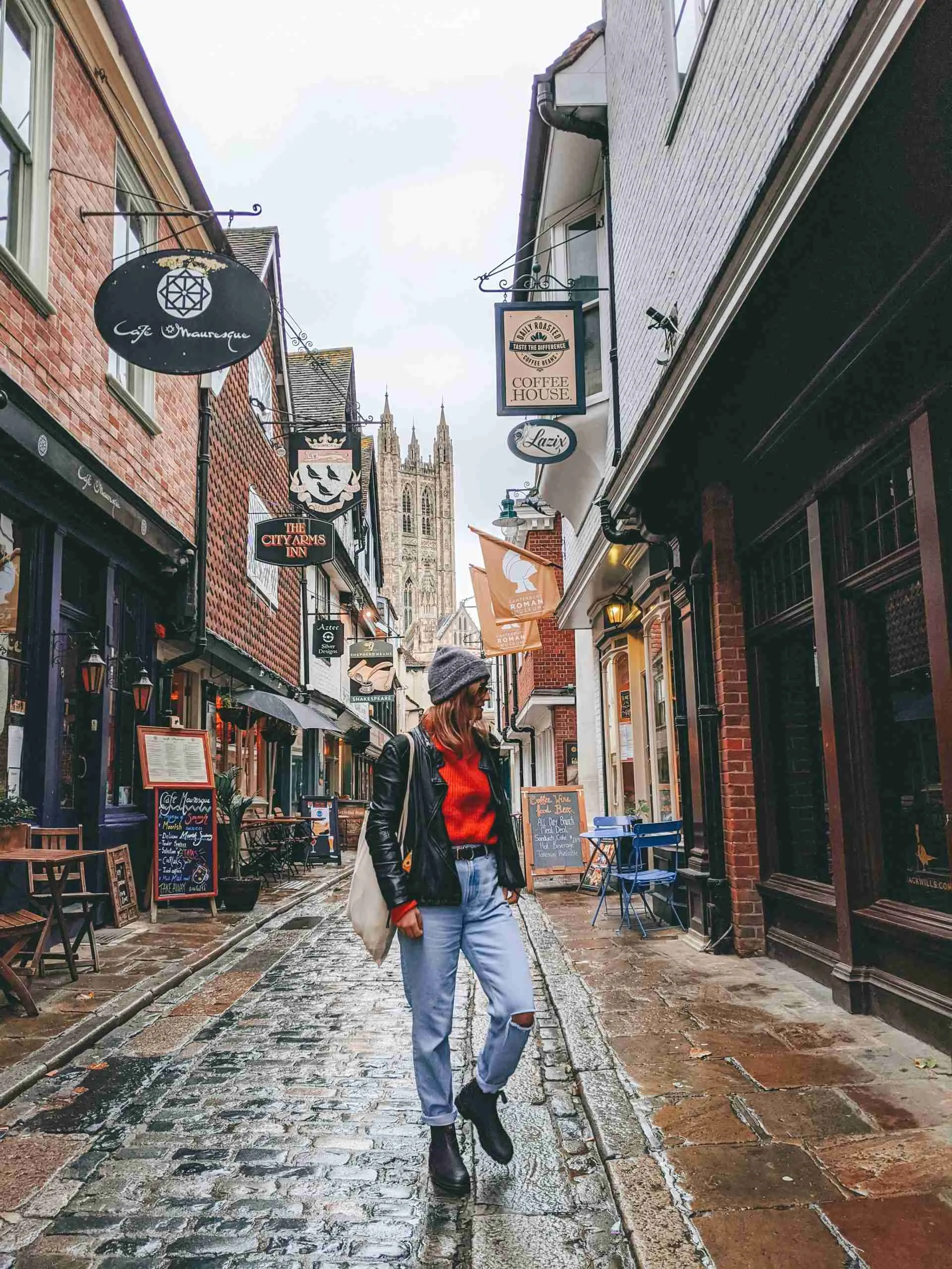 a girl standing in one of the tight streets in Canterbury - an underrated day trip from London 