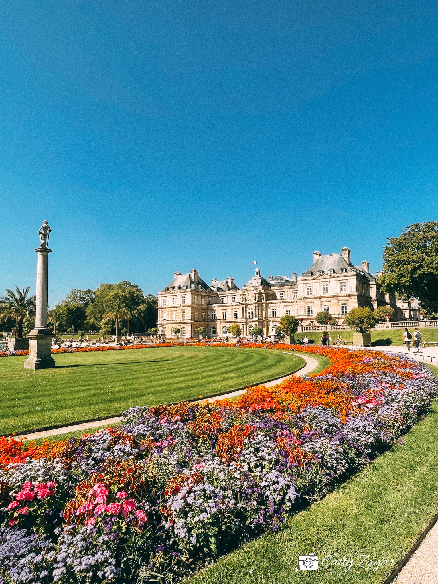 rows of flowers with the Luxembourg Palace in the background - a beautiful summer day in the Luxembourg Gardens 