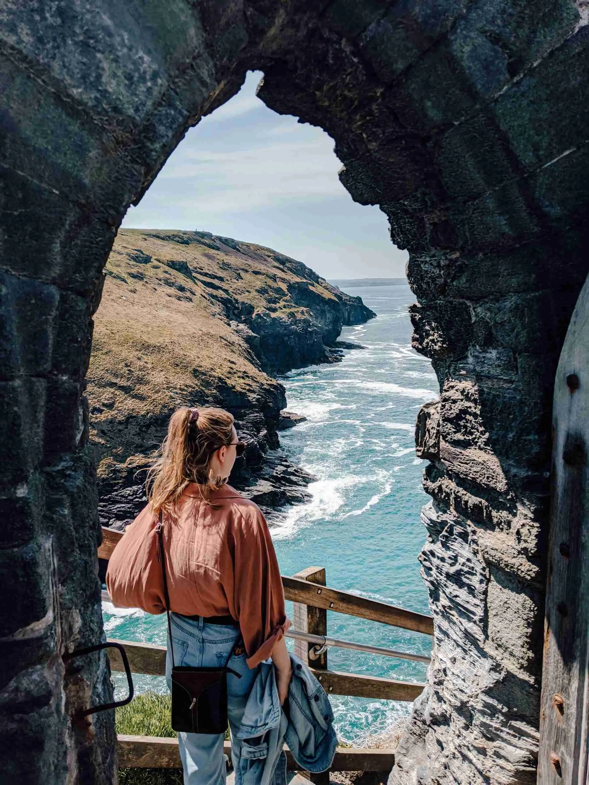 A girl looking at the view from Tintagel Castle. The HIGHLIGHT from our Cornwall road trip!