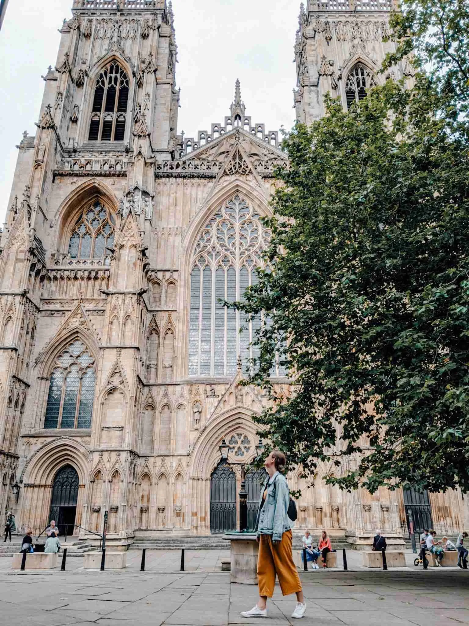 A girl walking past the York Cathedral, one of my favorite stops on our UK road trip