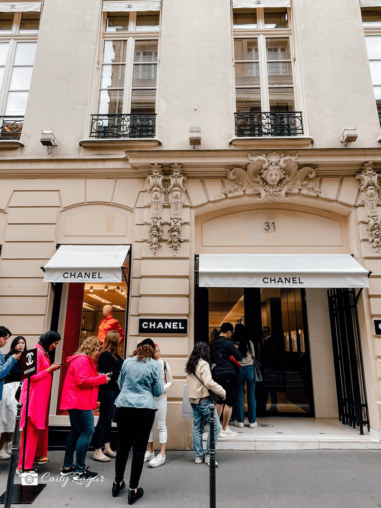 Customers in line to go inside the original Chanel shop in Paris