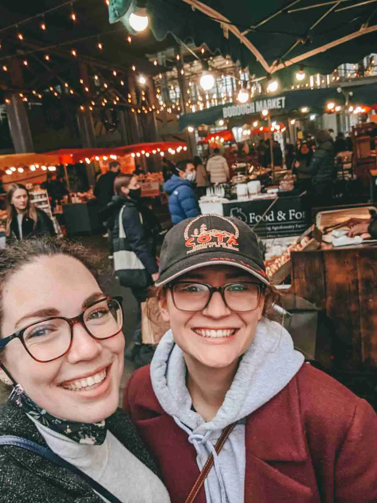 2 girls taking a selfie in front of Borough market - my personal favourite of the markets in London