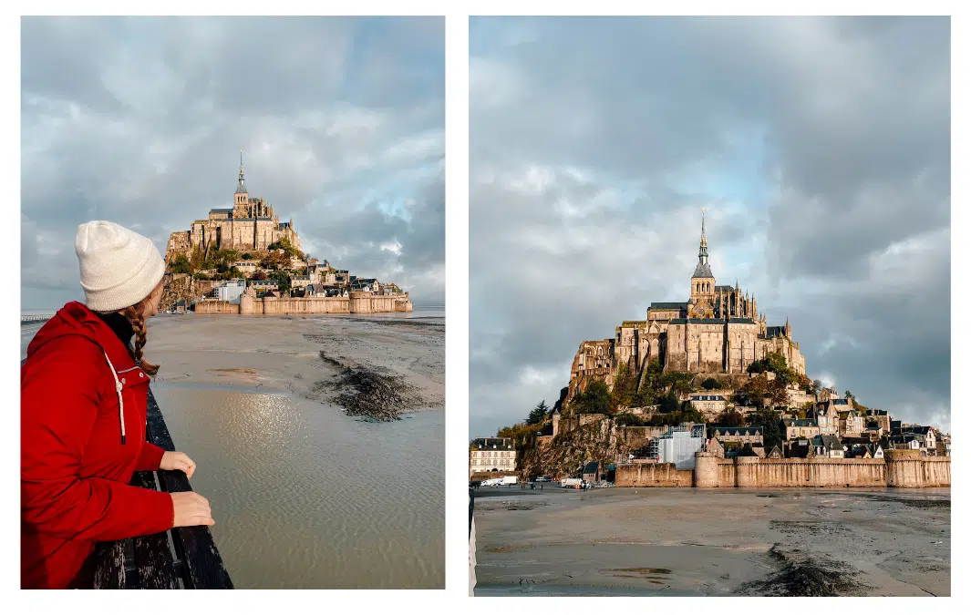 A girl looks at Mont St Michel in the distance on low tide