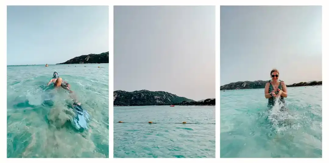 2 people splash in turquoise waters with a mountains in the background 