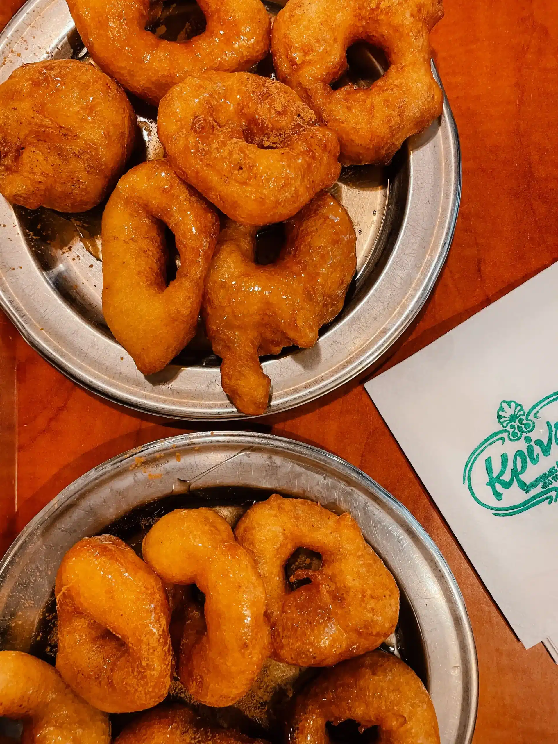 A highlight from this Athens food tour was a visit to a famous greek doughnut shop - a plate of these traditional doughnuts sit on a table