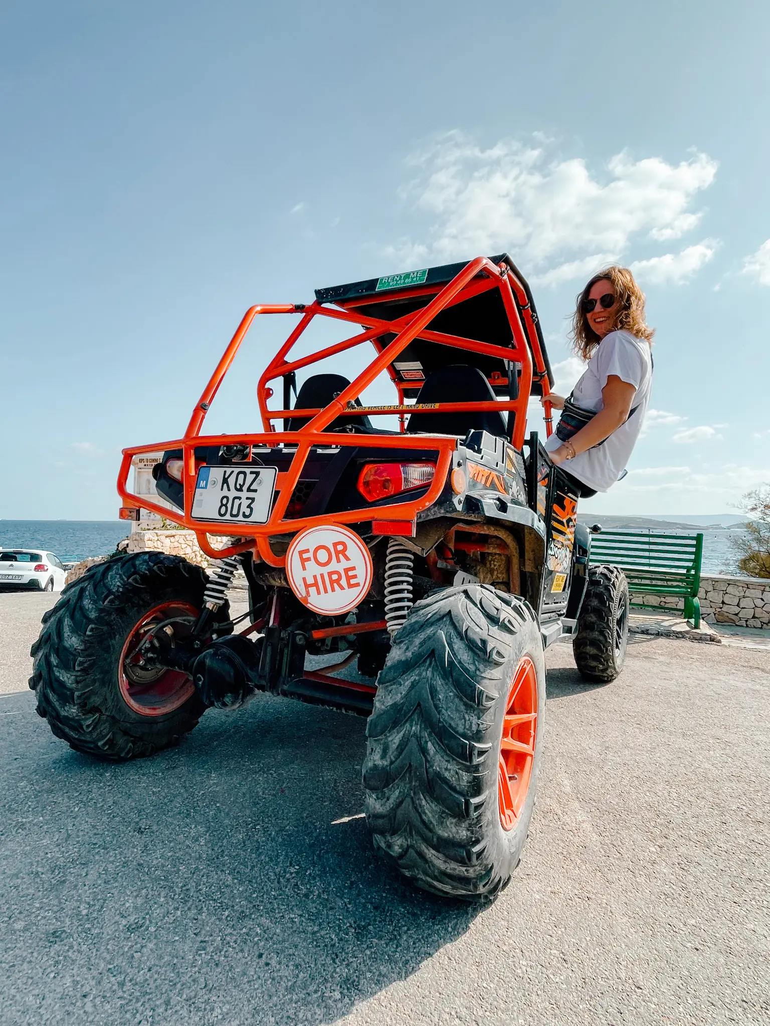 A girl hanging outside of a buggy to tour around Gozo. One of the best investments for the Malta budget 