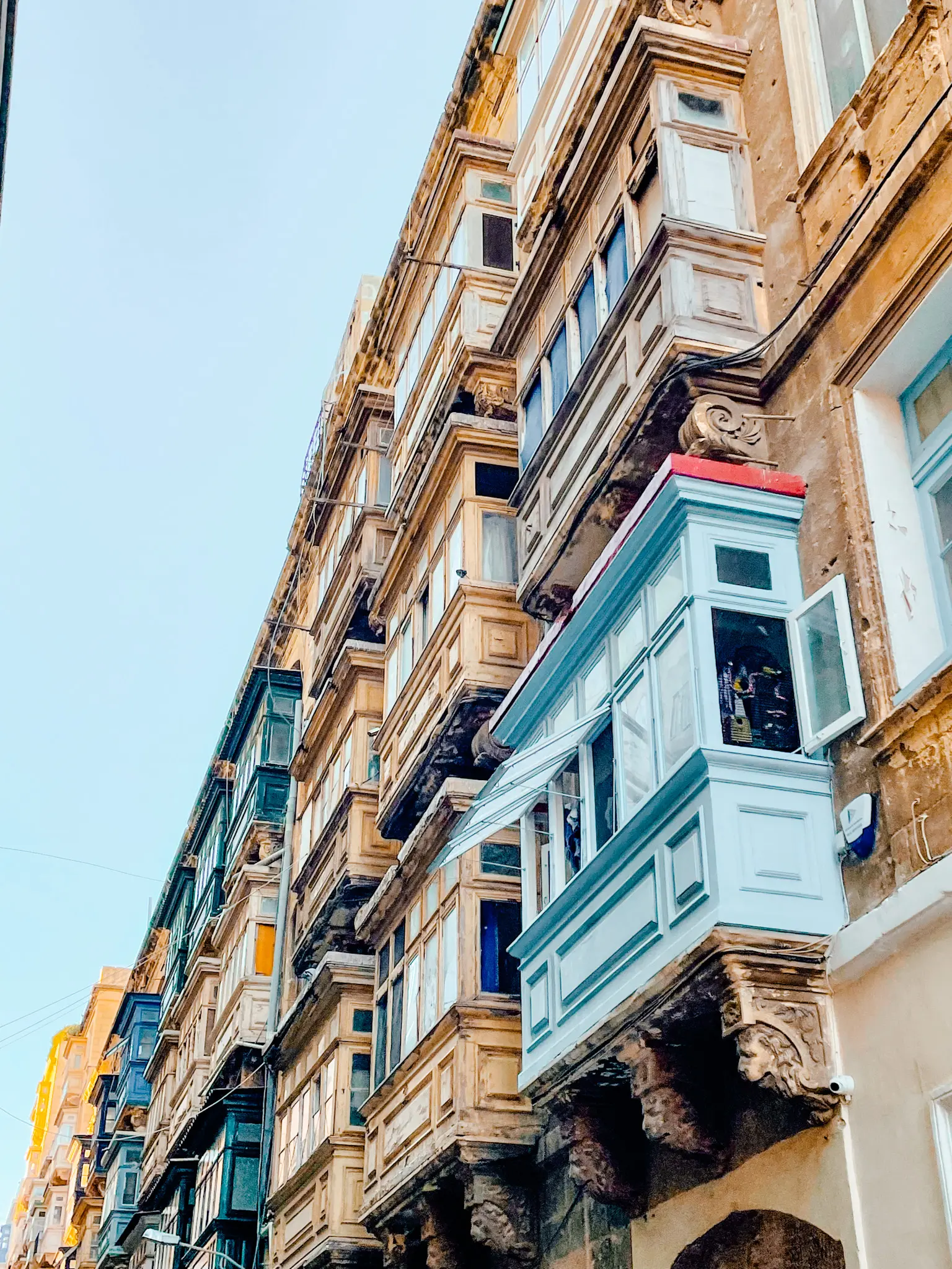 A street with colorful blue balconies.