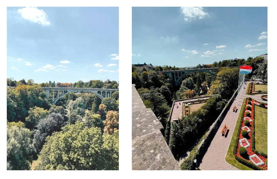 The view overlooking the valley and gardens in Luxembourg city with a view of a bridge in the distance and colorful flowers in the gardens