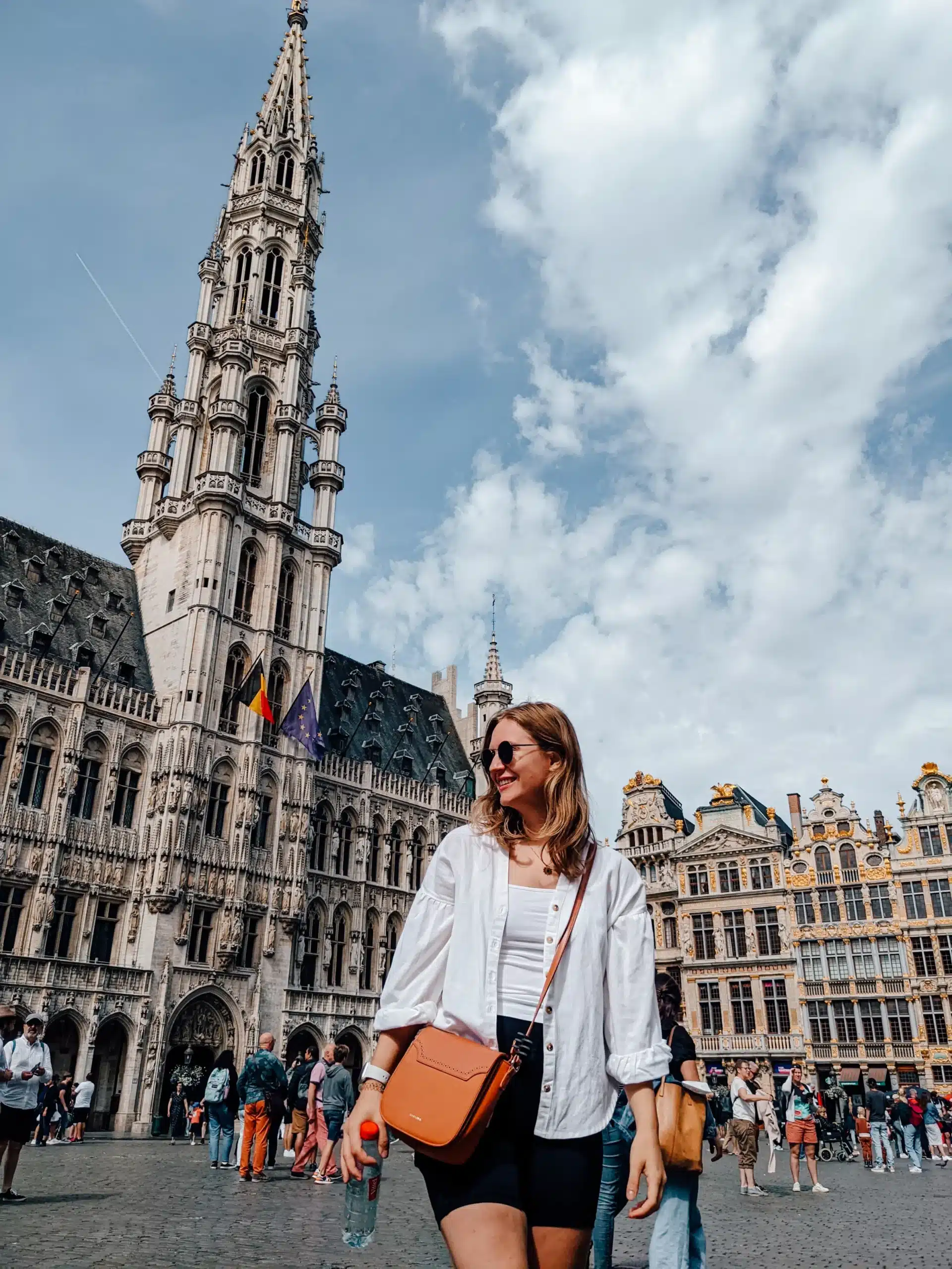 A girl standing in Brussels Grand Place - we parked outside of the town centre to stick to our road trip budget